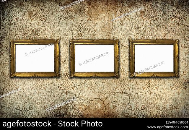 Golden vintage picture frame set with blank space on an old wall. Copy space, add photo or text