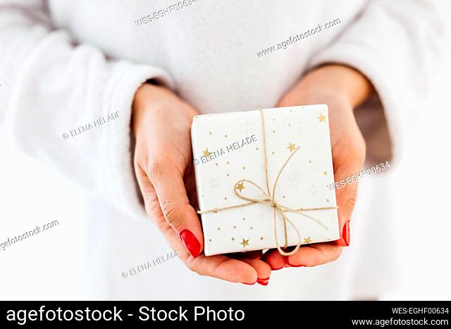 Hands of woman holding Christmas gift