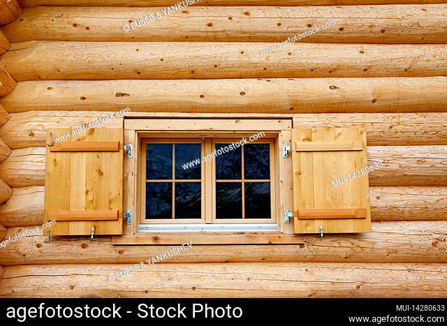 Windows in a log house from thick wooden beams