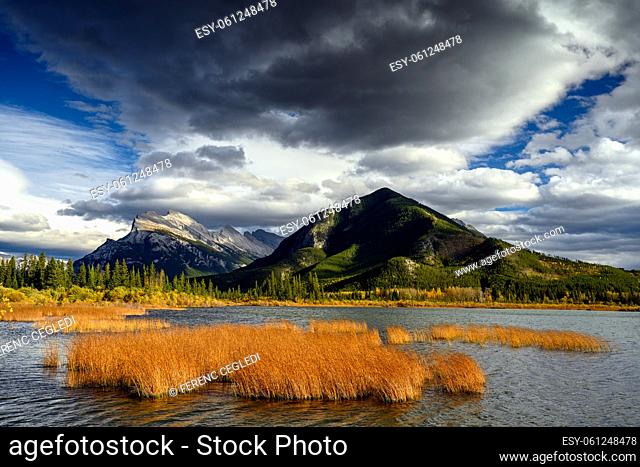 The combination of dramatic stormy sky over Mount Rundle (2949 M) and gorgeous warm sunset lights on Vermilion Lakes in the foreground make this image so...