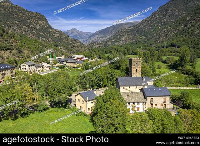 Aerial view of the Romanesque church of Santa Maria in Ribera de Cardós and the surrounding green fields in the Cardós valley (Pallars SobirÃ , Lleida