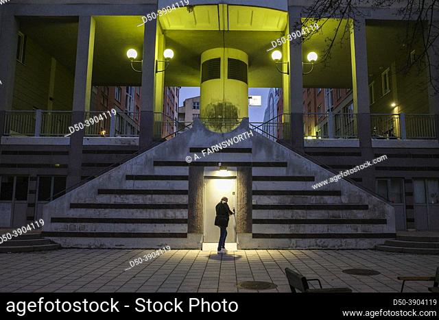 Stockholm, Sweden A man enters a secret door under a public staircase in the Fatburs district of Sodermalm at night