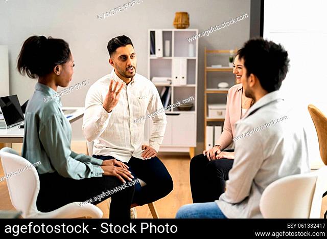 Two People Consoling Young Man During Group Therapy Session