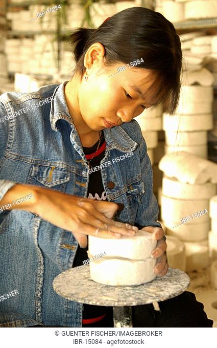 Woman working in a pottery Vietnam
