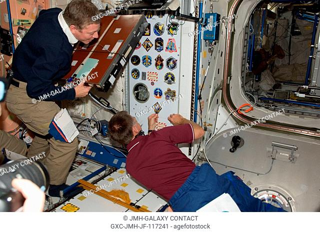 Inside the International Space Station's Node 1 or Unity, NASA astronaut Chris Ferguson, STS-135 commander, adds his mission's decal as the final piece of the...