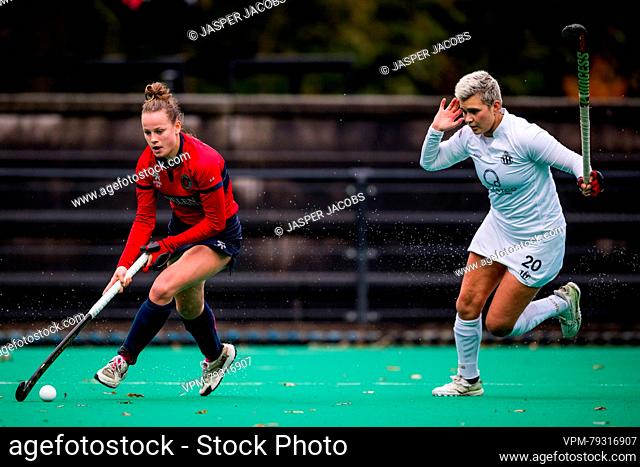 Dragon's Delphine Marien and Dragons' Magali Rounen fight for the ball during a hockey game between KHC Dragons and Royal Racing club de Bruxelles