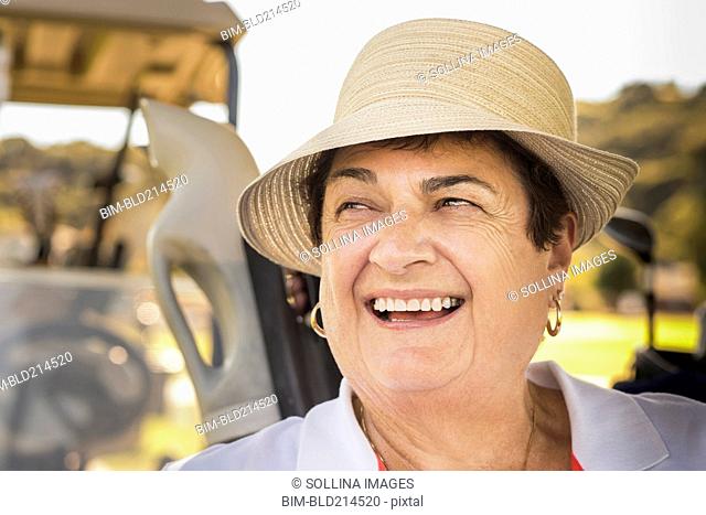 Close up of smiling older woman wearing hat