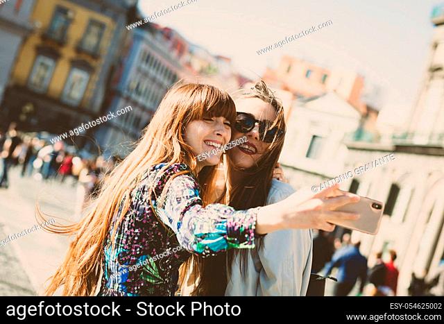 Two young adults take a selfie in Piazza del Plebiscito in Naples