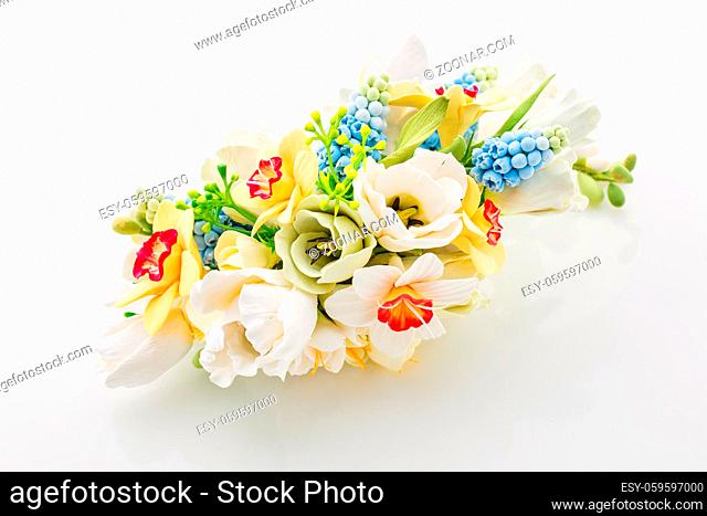 Beautiful handmade art clay spring flower bouquet. Bridal accessory. Over white background