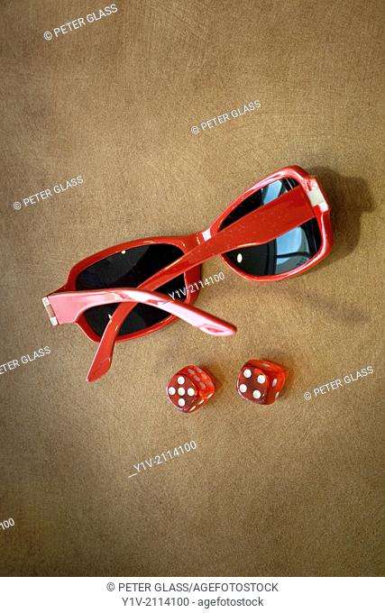 Pair of dice near sunglasses