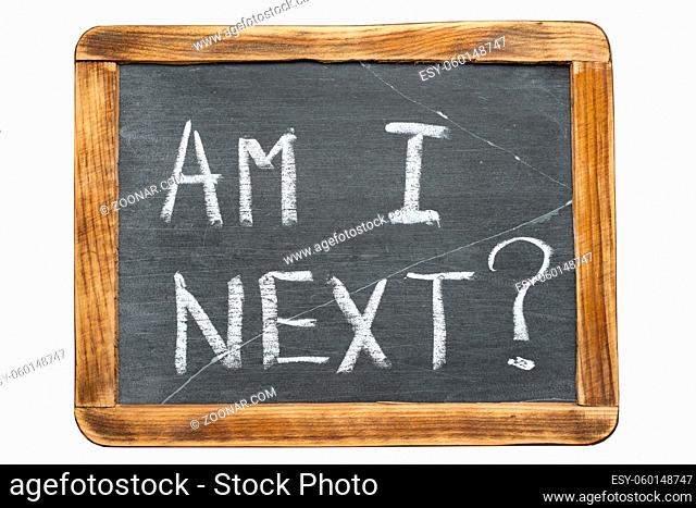 am I next question handwritten on vintage school slate board isolated on white