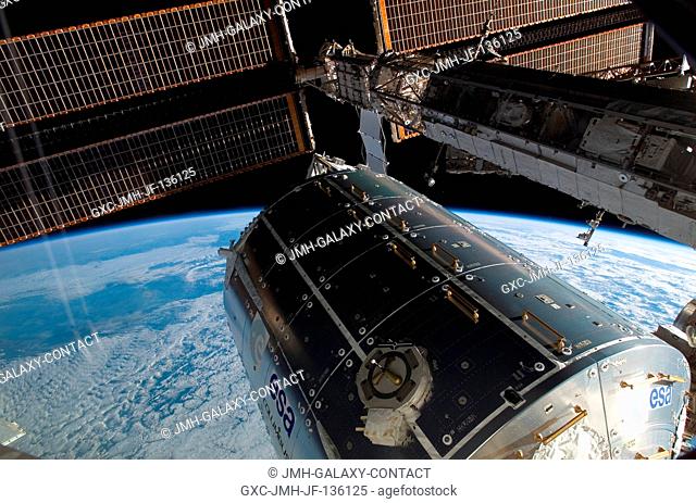 Backdropped by the blackness of space and Earth's horizon, the Columbus laboratory (center) -- the newest addition to the International Space Station -- is...