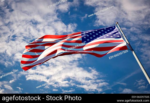 Beautiful national state flag of USA America fluttering at sky background. Low angle close-up USA America flag 3D artwork