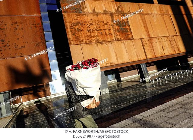 Gdansk, Poland A man carries roses on New Year's Day at the European Solidarity Centre, the Solidarity Museum, close to the famous Gdansk Shipyard that saw the...