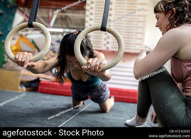 Female rock climbers training in climbing gym