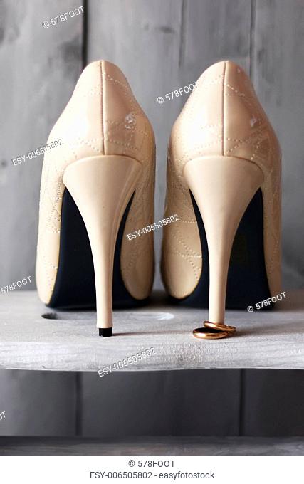 Photo of white shoes and wedding rings