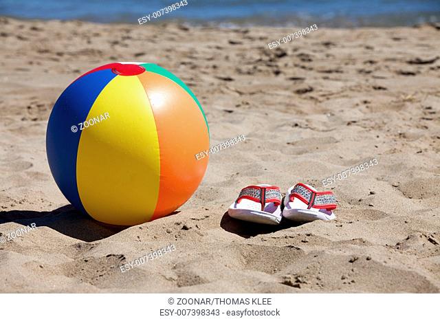 Water ball and flip-flops Flip flops on the beach