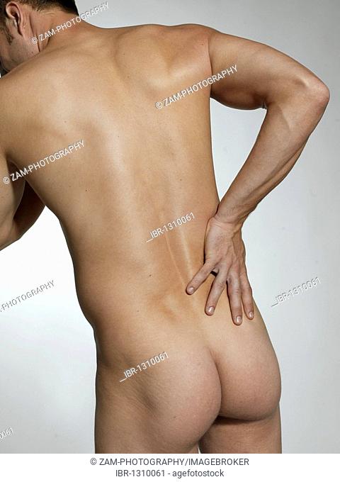 Naked man, nude, buttocks and back, back pain