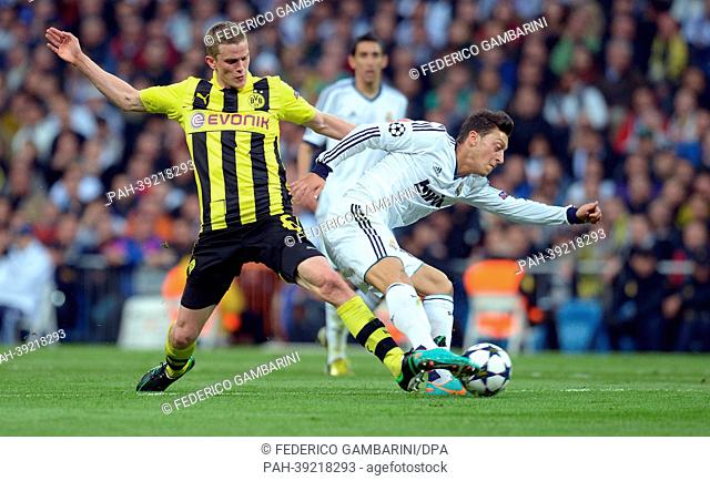 Dortmund's Sven Bender (L) and Real's Mesut Oezil vie for the ball during the UEFA Champions League semi final second leg soccer match between Borussia Dortmund...