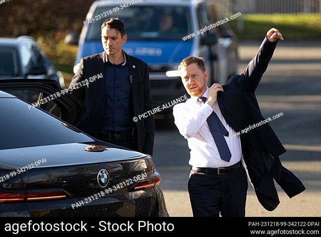 18 December 2023, Saxony, Riesa: Michael Kretschmer (CDU), Minister President of Saxony, gets out of an official car before the start of the inauguration of a...
