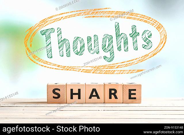 Share your thoughts sign on a desk made of wood