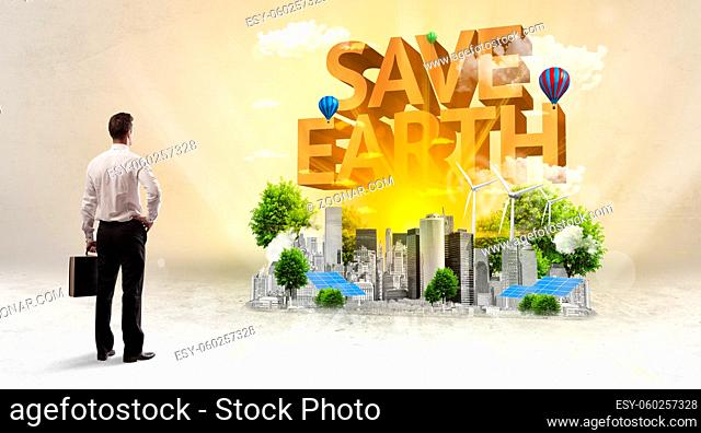 Rear view of a businessman standing in front of SAVE EARTH inscription, Environmental protection concept