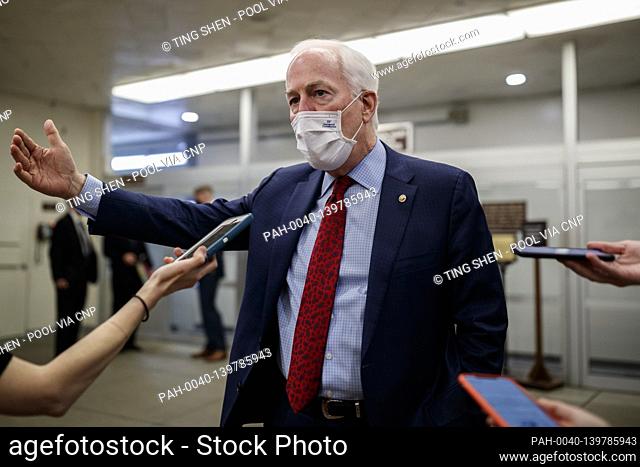 Senator John Cornyn, a Republican from Texas, wears a protective mask while speaking to members of the press in the Senate Subway at the U.S