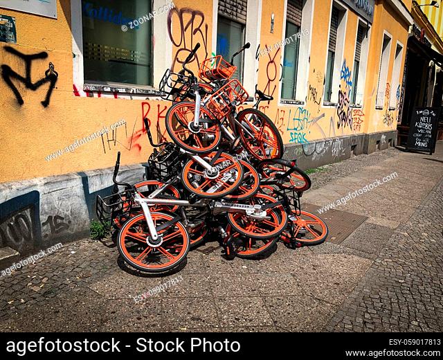 Berlin, Germany - June 2019: Many Mobike bike sharing bicycles on a pile on the street in Berlin, Germany