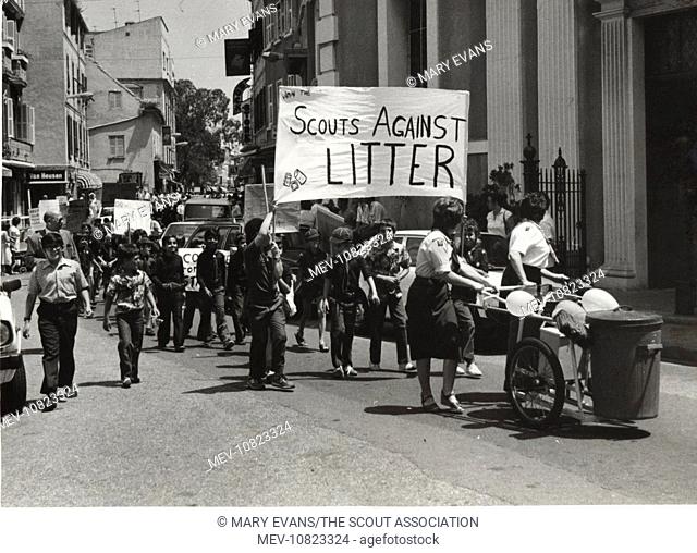 Gibraltar cub scouts taking part in an anti-litter campaign, marching along a main street