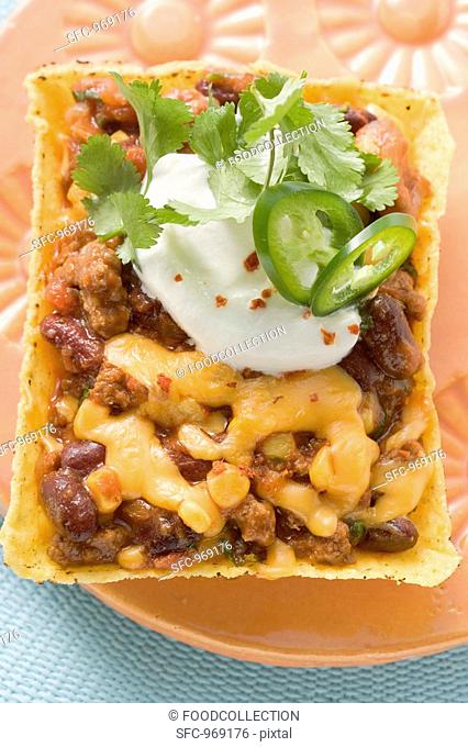 Chili con carne with cheese in corn shell Mexico