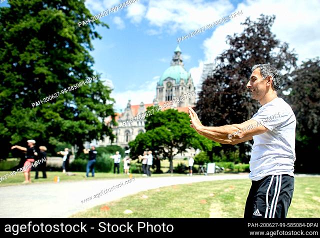 27 June 2020, Lower Saxony, Hanover: Ìmit from Hannover takes part in a TaiChi exercise in the Maschpark. The TaiChi and Qigong day originally planned for April...