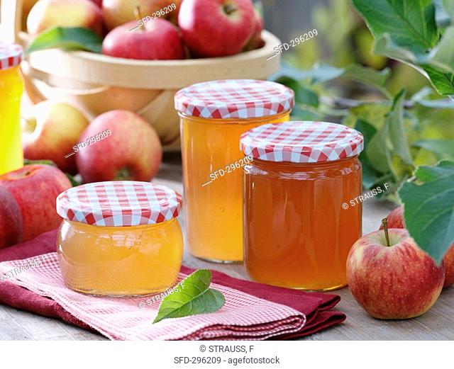 Jars of apple jelly, fresh apples