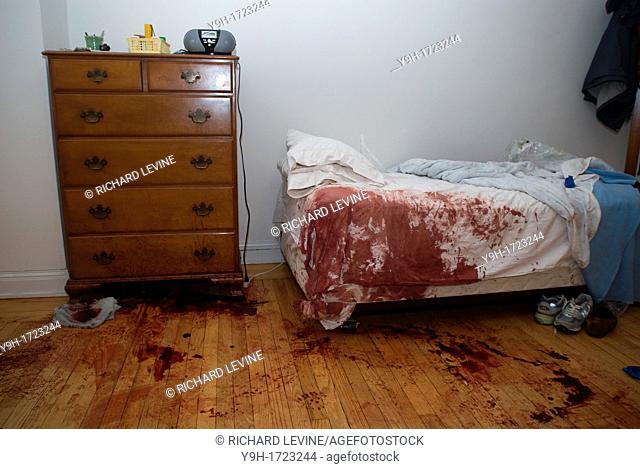 Blood stained bed and floor are seen in an apartment in New York after a horrific accident