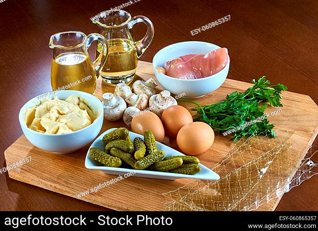 Ingredients for cooking jellied chicken with mushrooms pickled cucumber lettuce Complete collection of recipes