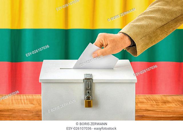 man putting ballot in the ballot box - lithuania