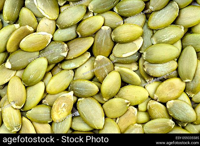 food background - many hulled pumpkin seeds