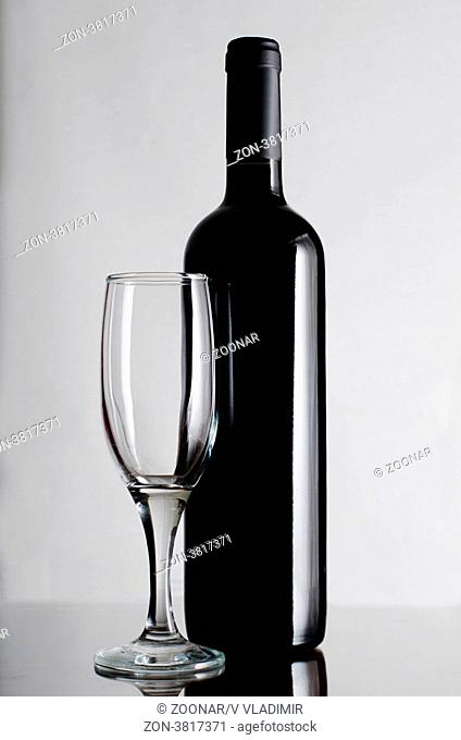 Red wine bottle on a grey background