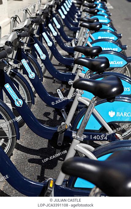 England, London, Mayfair. A row of Barclays cycle hire bikes Boris Bikes in a docking station