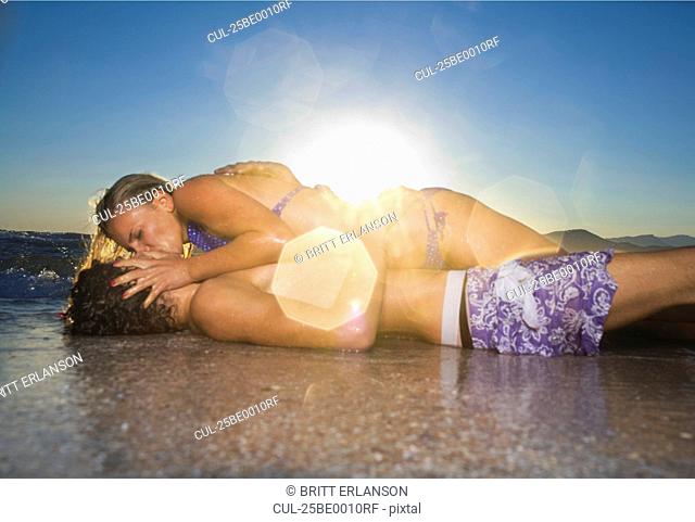 Sexy cple. kiss in tide at beach