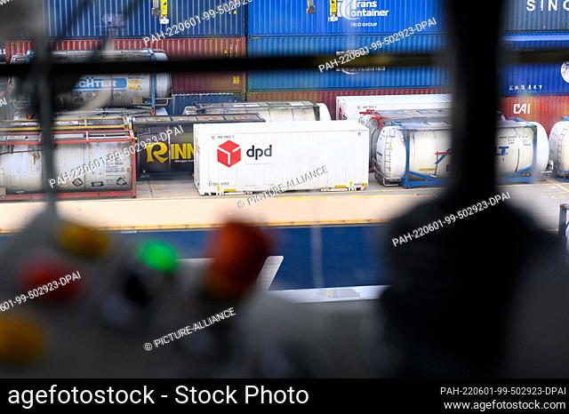 30 May 2022, Hamburg: One of the DPD containers can be seen through the window of a gantry crane operator's cab at the DUSS terminal in Hamburg Billwerder