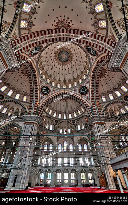Fatih Mosque, a public Ottoman mosque in the Fatih district of Istanbul, Turkey, low level angled shot showing huge arches