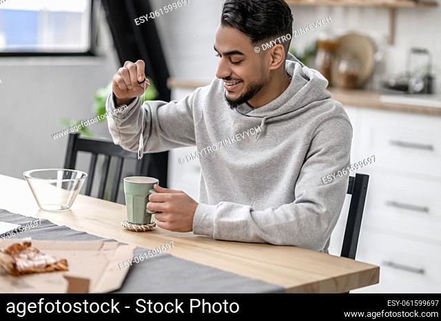 Preparing tea. A man spending morning at home and preparing tea