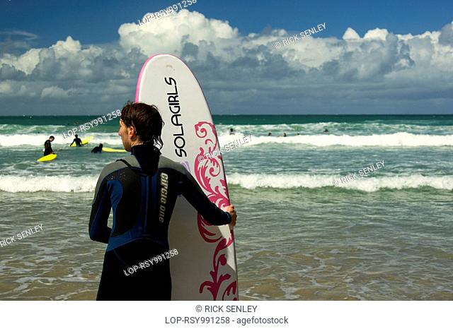 Surfer holding his board at Newquay