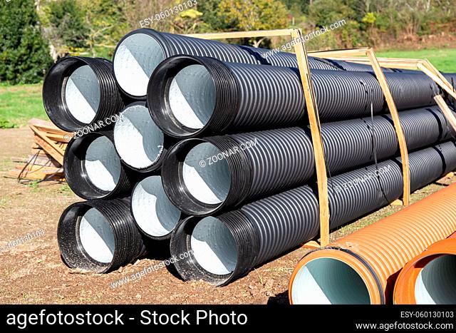 Pile of Polyethylene drainage pipes on construction site
