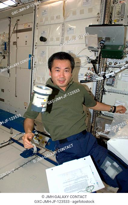Japan Aerospace Exploration Agency (JAXA) astronaut Koichi Wakata, Expedition 1920 flight engineer, is pictured near a Microbial Air Sampler floating freely in...