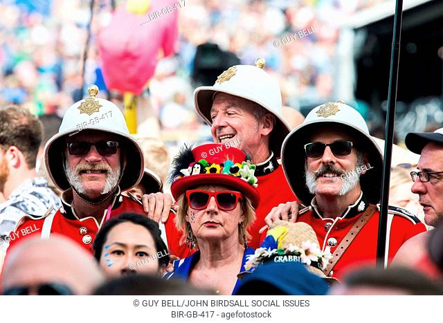 Redcoat soldiers in pith helmets watching Burt Bacharach on the Pyramid stage. The 2015 Glastonbury Festival, Worthy Farm, Glastonbury