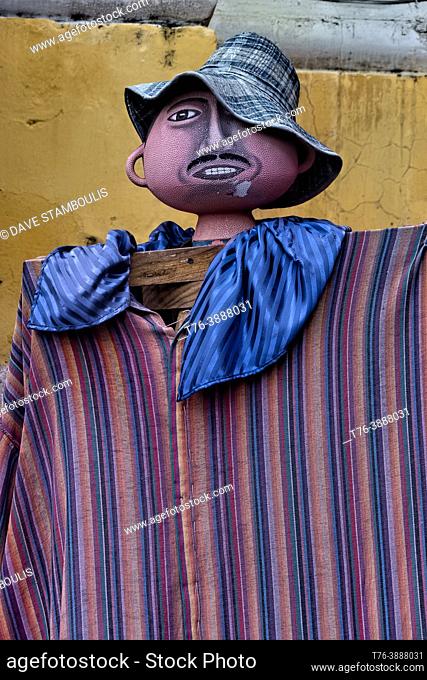 Traditionally dressed mannequin outside of the La Merced Convent, Antigua, Guatemala,