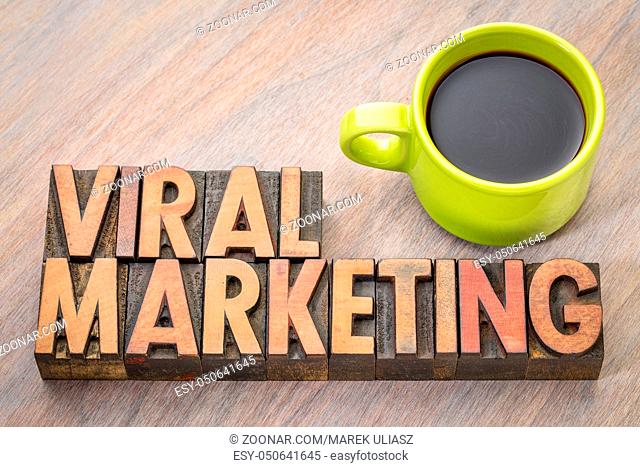 viral marketing word abstract in vintage letterpresss wood type with a cup of coffee