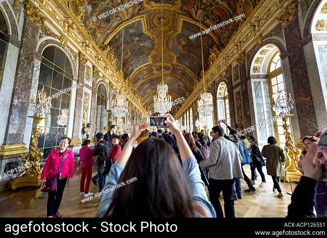 Tourist taking photos at the Hall of Mirrors in Versailles palace