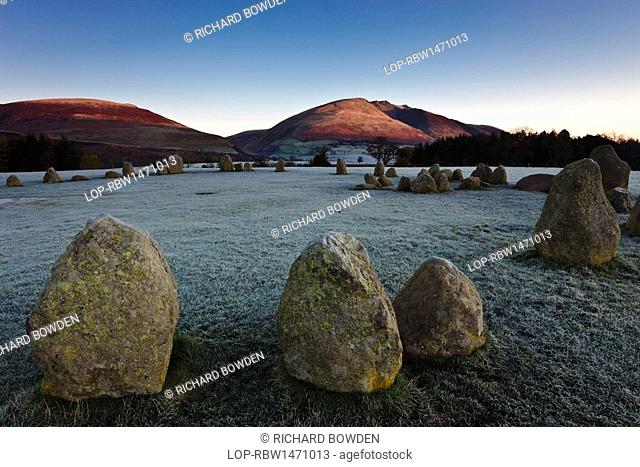 England, Cumbria, near Keswick. Castlerigg Stone Circle on a frosty morning while the first rays of light hit the slopes of Blencathra in the Lake District